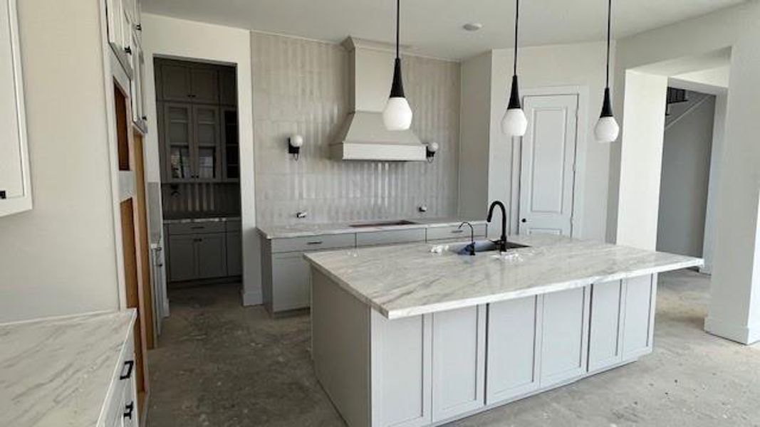 Up graded backsplash from counter to ceiling. A large upgraded butlers pantry gives extra storage for a place to display your special China or collectables.
