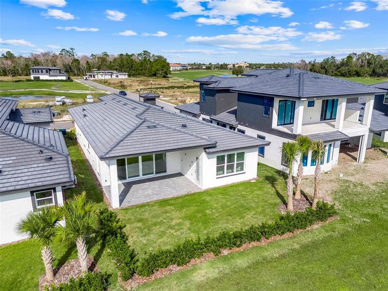 Exterior details and patio area of a home in Hampton Green at Providence, Davenport (Image 30).