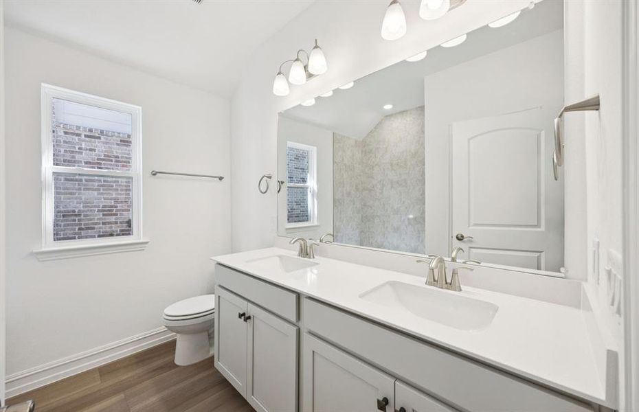 Secondary bathroom with a window providing natural light Secondary bathroom with a window providing natural light
