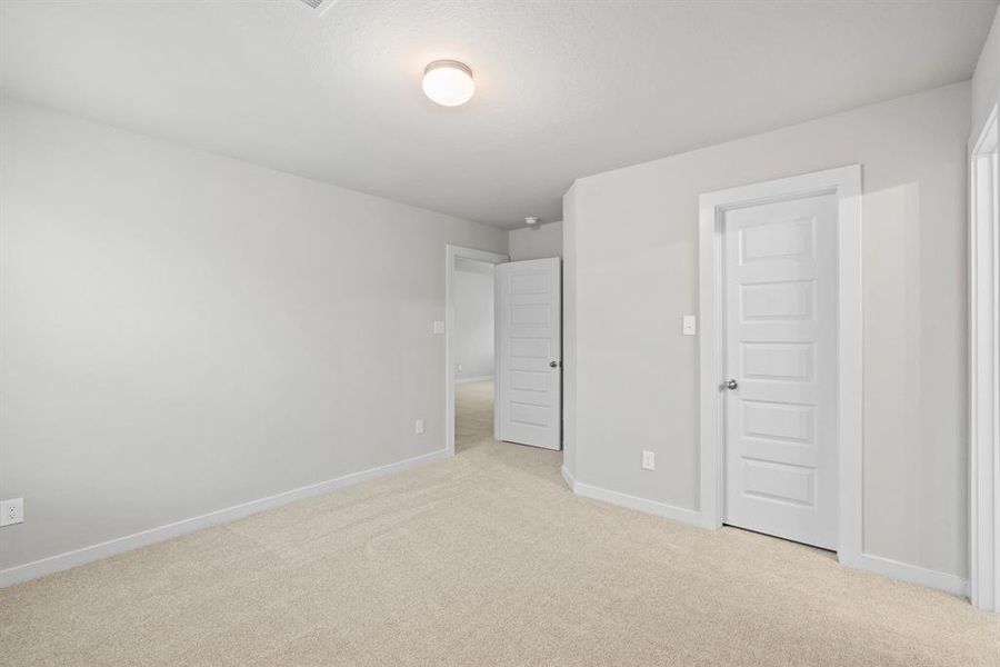 Generously sized secondary bedrooms featuring spacious closets, soft and inviting carpeting underfoot, large windows allowing plenty of natural light, and the added touch of privacy blinds for your personal retreat. Sample photo of completed home with similar floor plan. As-built interior colors and selections may vary.