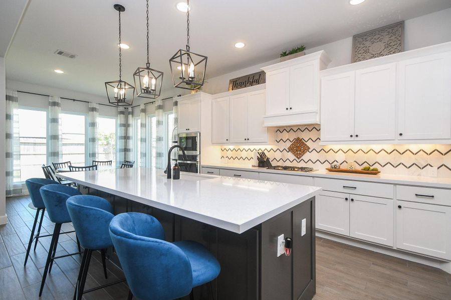Marble backsplash accompanied by matte black fixtures and pulls