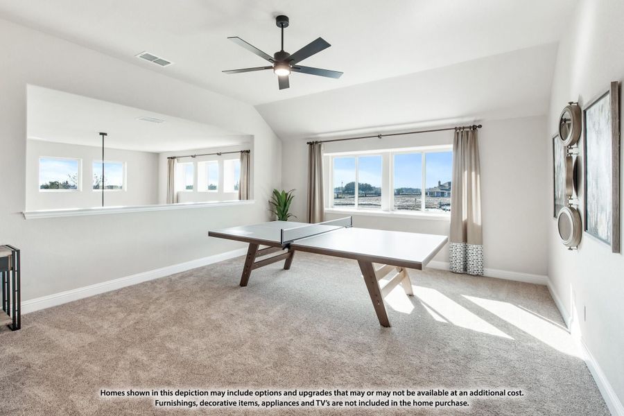 Game room with ping pong table, carpet flooring, vaulted ceiling, ceiling fan, and large windows Game room with ping pong table, carpet flooring, vaulted ceiling, ceiling fan, and large windows