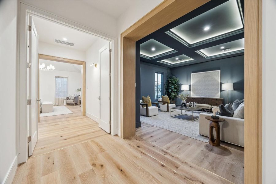 The upstairs landing branches off into the media room and primary suite, with three spacious bedrooms with en suite bathrooms and a guest bathroom are behind. Rift-sawn white oak casements add elegance to the space, as do real brass inlays in the oak flooring to demarcate the rooms.
