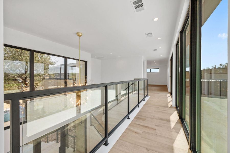 Hallway with recessed lighting and light wood-type flooring