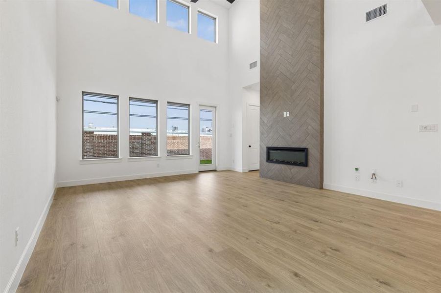 Featuring dual stacked windows and a stunning floor to ceiling fireplace, you will love hosting family & friends in this over the top family room!