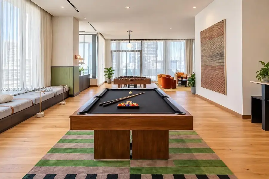 Open-concept space featuring floor-to-ceiling windows, wood-finish flooring, recessed lighting, and built-in bench seating Open-concept space featuring floor-to-ceiling windows, wood-finish flooring, recessed lighting, and built-in bench seating