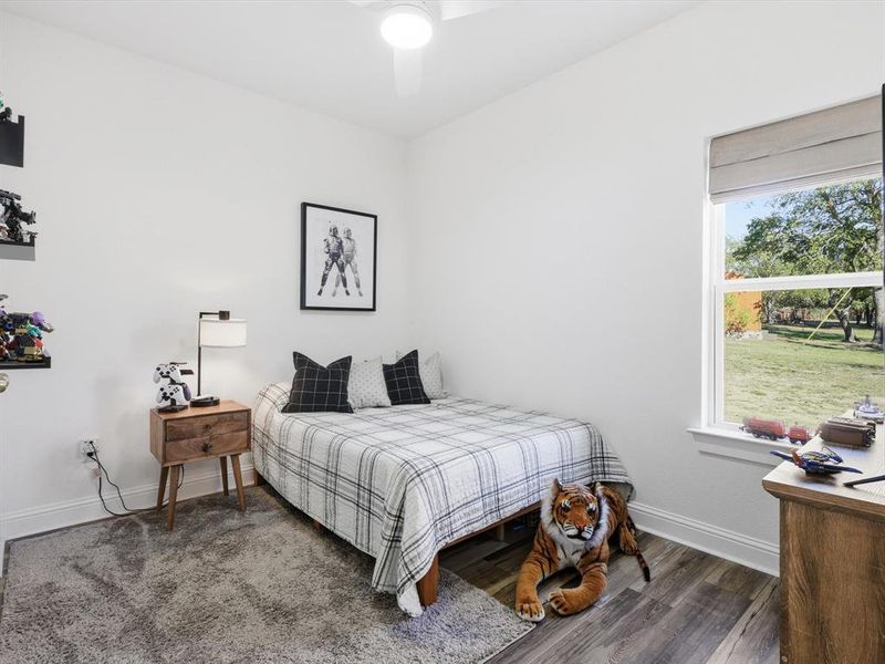 Bedroom featuring dark wood-type flooring and ceiling fan