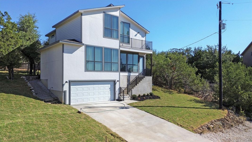 Front exterior of a new home in , Dripping Springs, TX, highlighting curb appeal (Image 24).