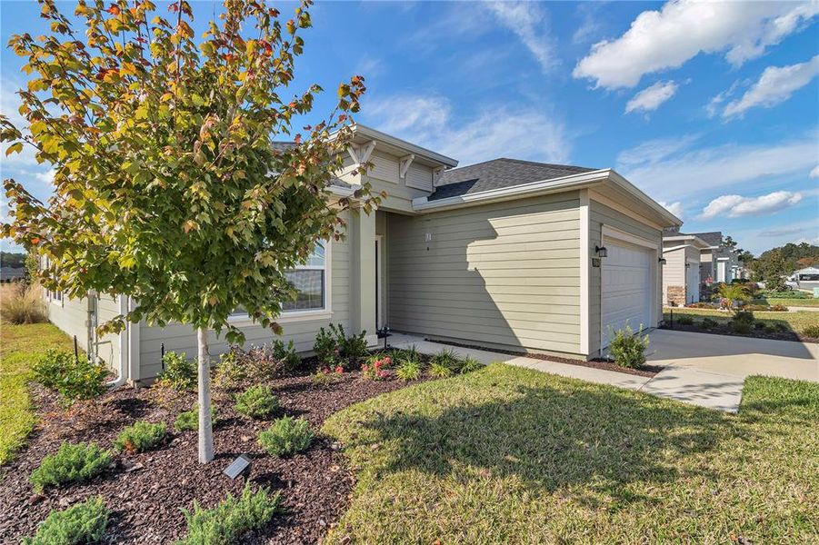 Front exterior of a new home in Liberty Village: Liberty Village - Phase One, Ocala, FL, highlighting curb appeal (Image 27). Front exterior of a new home in Liberty Village: Liberty Village - Phase One, Ocala, FL, highlighting curb appeal (Image 27).