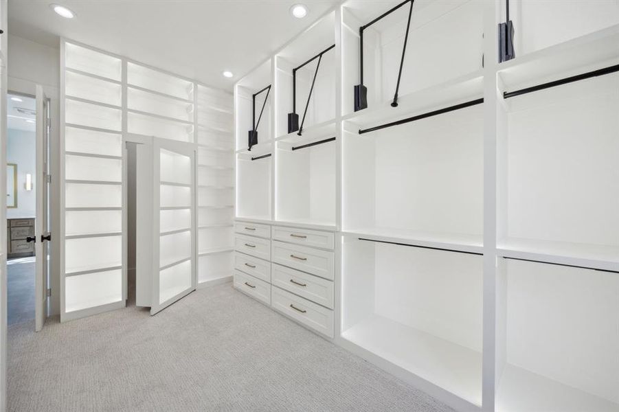 Spacious closet with light colored carpet Spacious closet with light colored carpet