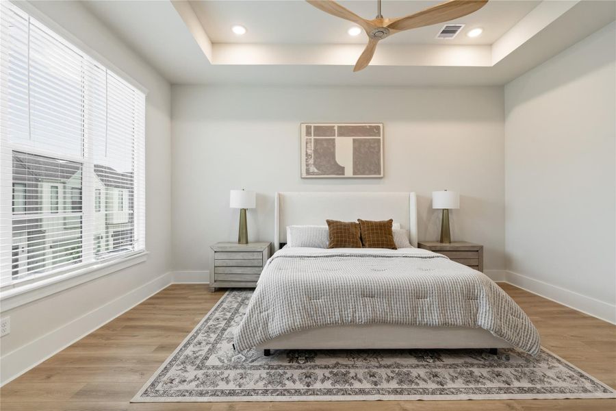 A calm and inviting primary retreat, where natural light fills the space and tray ceilings elevate the design. His and her closets bring ease to daily living. A calm and inviting primary retreat, where natural light fills the space and tray ceilings elevate the design. His and her closets bring ease to daily living.