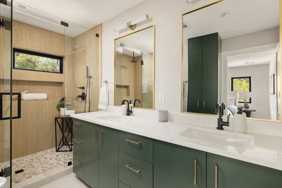 Bathroom with plenty of natural light, double vanity, and a shower stall