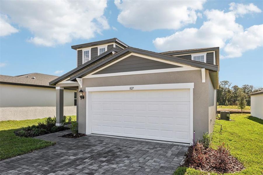 Front exterior of a new home in The Reserve at Hammock Oaks - Classic Series, Lady Lake, FL, highlighting curb appeal (Image 26).