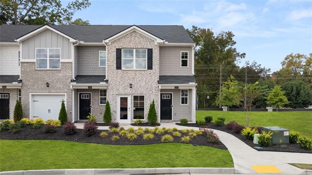 Front exterior of a new home in Young's Crossing, Stone Mountain, GA, highlighting curb appeal (Image 2).