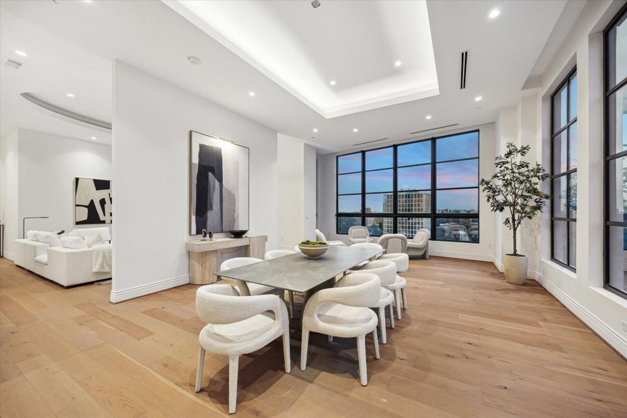 This photo captures the seamless flow of the living areas, highlighting the open concept design that defines this home. The spacious dining room flows into the inviting living room, emphasizing the interconnected layout that is perfect for both casual living and sophisticated entertaining. This photo captures the seamless flow of the living areas, highlighting the open concept design that defines this home. The spacious dining room flows into the inviting living room, emphasizing the interconnected layout that is perfect for both casual living and sophisticated entertaining.