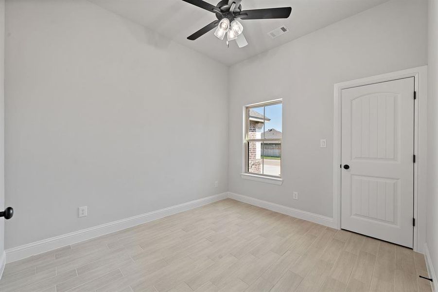 Unfurnished room with light wood-type flooring and a ceiling fan Unfurnished room with light wood-type flooring and a ceiling fan