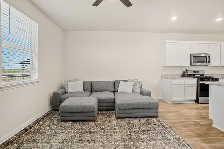 An open concept living area seamlessly blends comfort with culinary convenience.