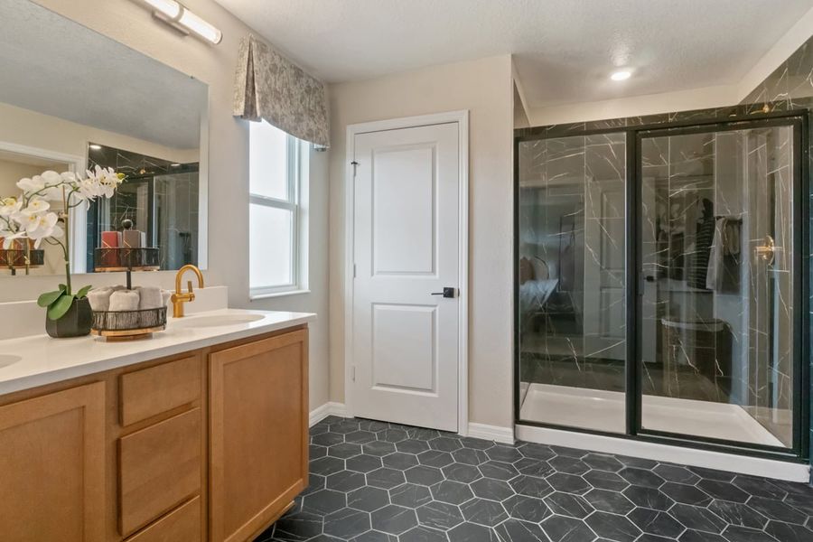 Walk-in shower with tile surround at primary bath