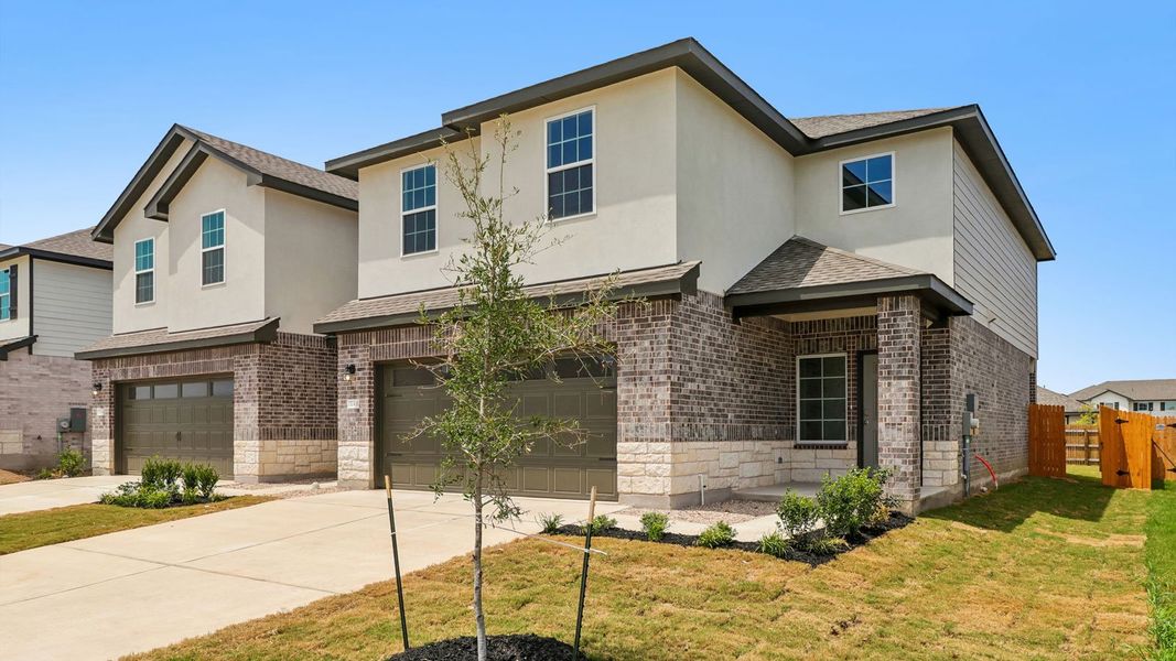 Front exterior of a new home in Palomino, Manor, TX, highlighting curb appeal (Image 18).