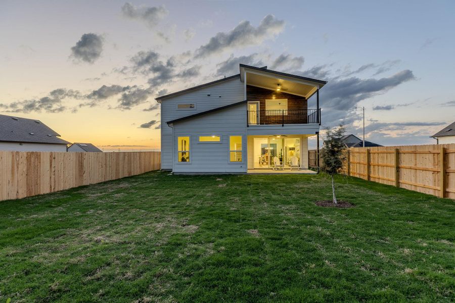 Rear view of house featuring a patio area and a fenced backyard