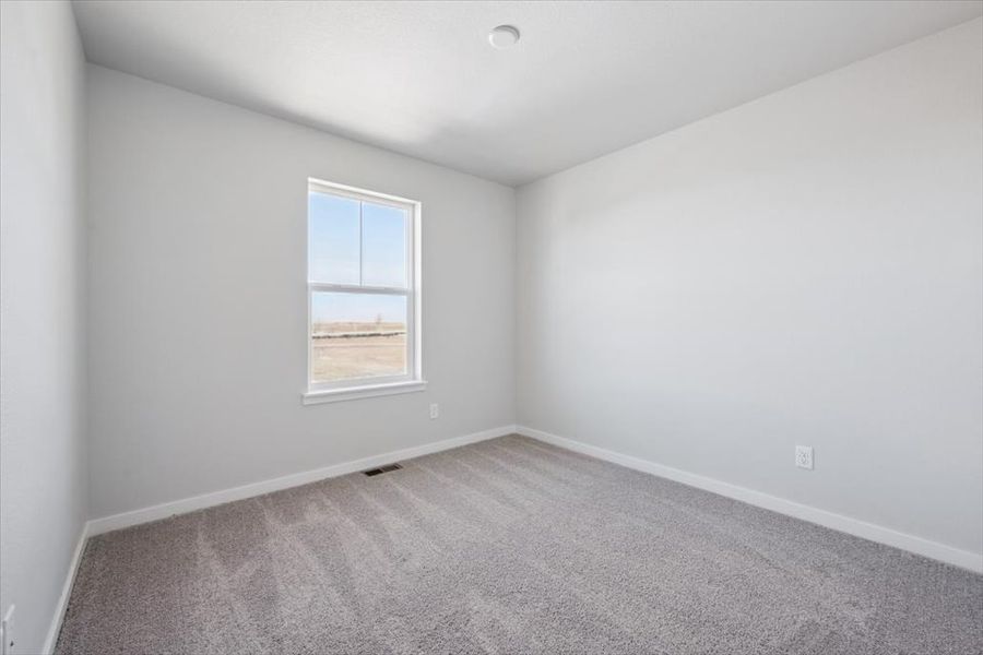 A room with a window and carpet. A room with a window and carpet.