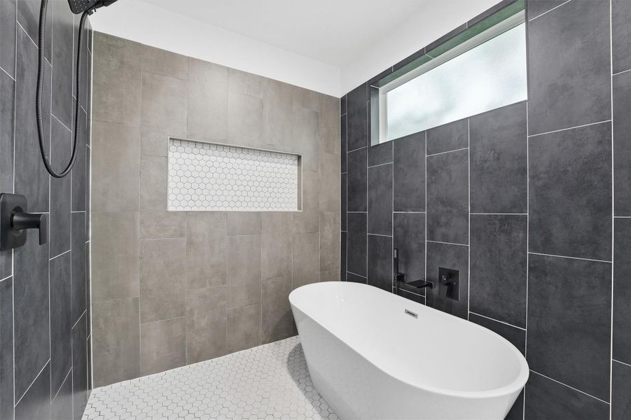 Fully enclosed bath and shower area with large soaker tub and even an additional window to let in more natural light!