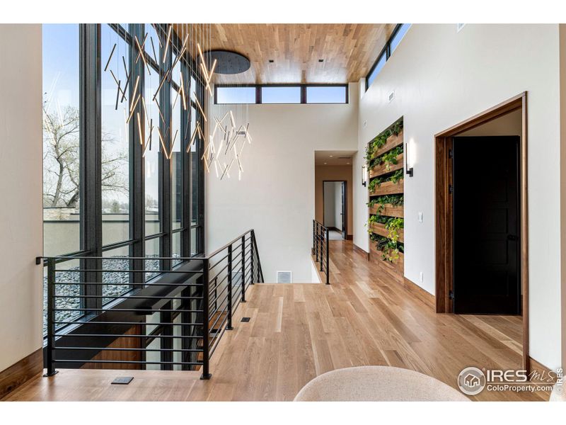 Dual Kuzco Chandeliers. Elevated Weathershield windows with motorized Lutron Blinds & Lutron lights throughout, all controlled through a complete Savant home automation system. Living plant wall & elevator between floors.