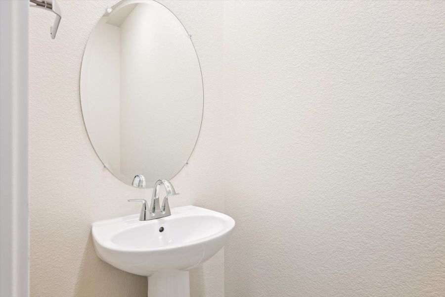 A mirror above a sink.