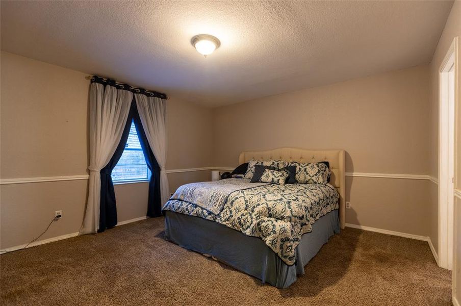 Carpeted bedroom featuring a textured ceiling Carpeted bedroom featuring a textured ceiling