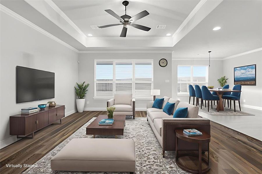 VIRTUALLY STAGED Living area featuring plenty of natural light, ornamental molding, dark wood-style flooring, a ceiling fan, and recessed lighting