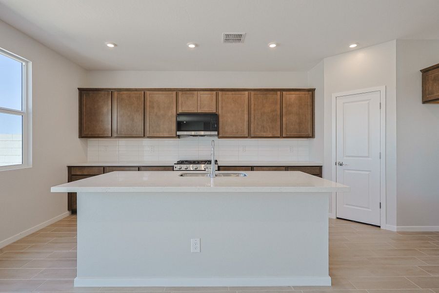 A kitchen with wooden cabinets. A kitchen with wooden cabinets.