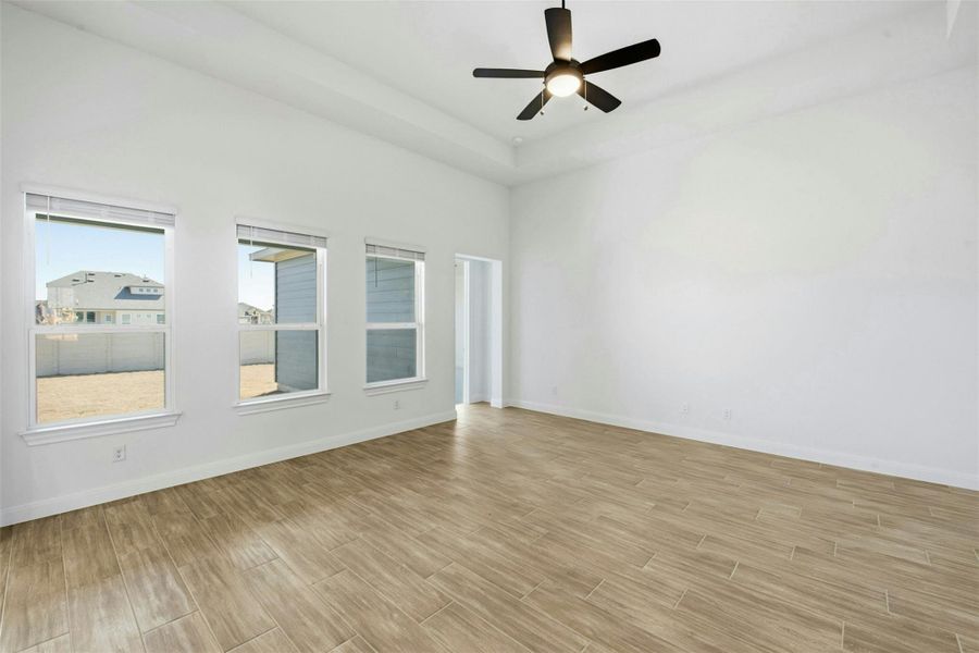 Unfurnished room featuring wood finish floors and a ceiling fan