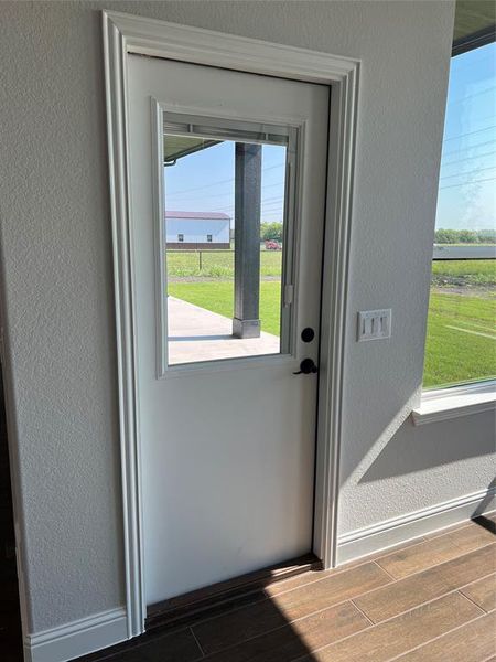 Entryway featuring a textured wall and wood finish floors