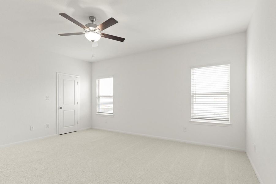 Spare room with light colored carpet and a ceiling fan
