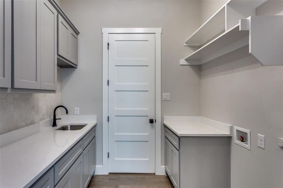Laundry room with cabinet space, dark wood-type flooring, and washer hookup Laundry room with cabinet space, dark wood-type flooring, and washer hookup
