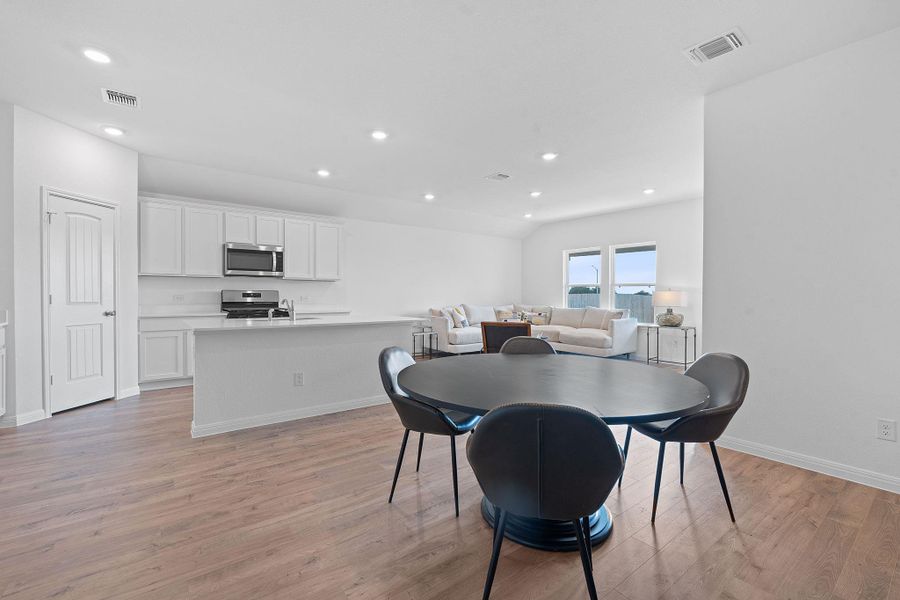 Dining area with recessed lighting and light wood-style floors Dining area with recessed lighting and light wood-style floors