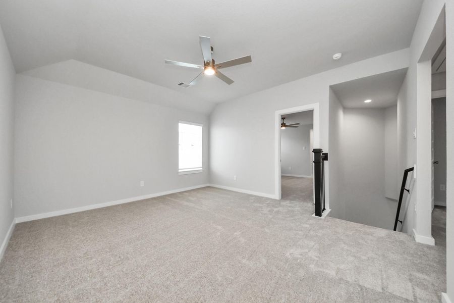 Come upstairs and enjoy a day of leisure in this fabulous game room! This is the perfect hangout spot or adult game room! Features plush carpet, high ceilings, custom paint and windows for plenty of natural light. Sample photo of completed home with similar floor plan. Actual colors and selections may vary. Come upstairs and enjoy a day of leisure in this fabulous game room! This is the perfect hangout spot or adult game room! Features plush carpet, high ceilings, custom paint and windows for plenty of natural light. Sample photo of completed home with similar floor plan. Actual colors and selections may vary.