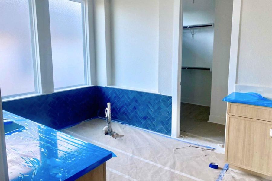 Bathroom featuring a spacious closet and a tub