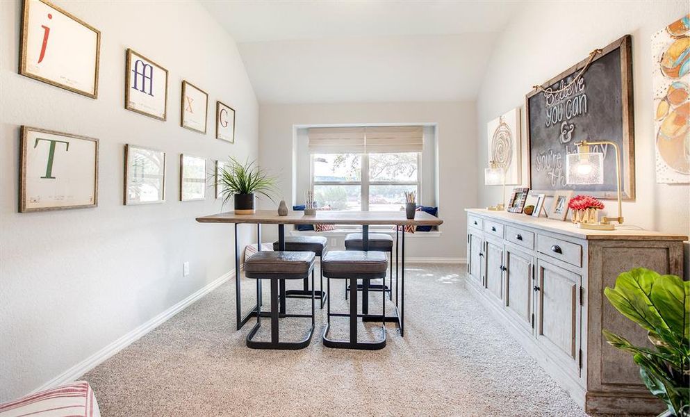 Dining area with vaulted ceiling and light colored carpet Dining area with vaulted ceiling and light colored carpet