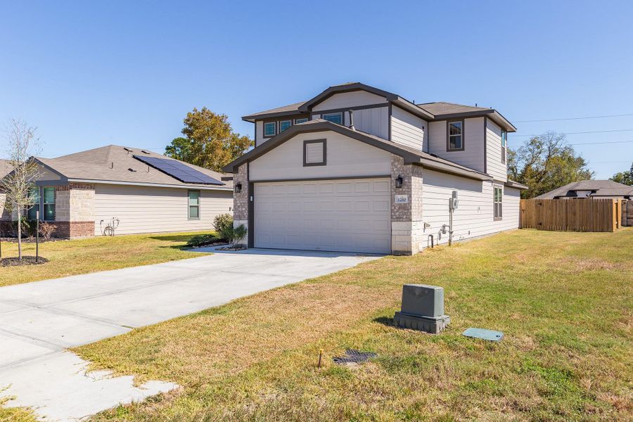 Front exterior of a new home in The Villages at Westpointe, Dayton, TX, highlighting curb appeal (Image 22).