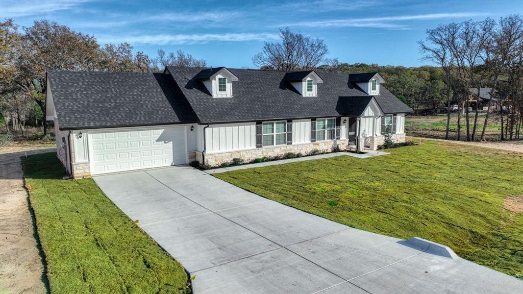 Front exterior of a new home in , Poolville, TX, highlighting curb appeal (Image 21).