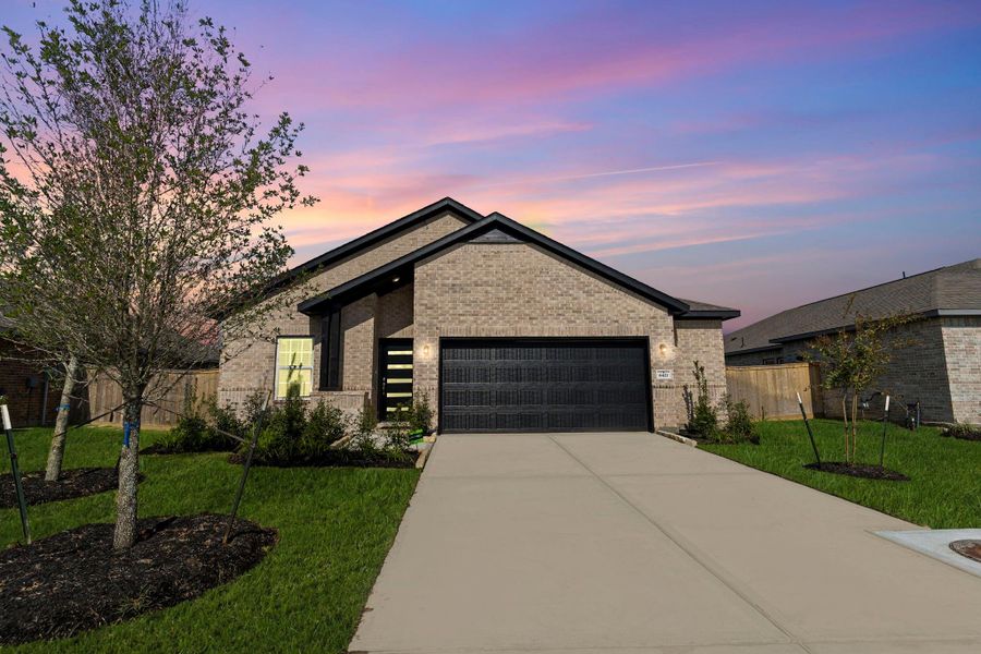 The front of the home glows beautifully at sunset, offering a peaceful and welcoming evening view that truly feels like home.  2 1/2 garage for all your storage needs.  What a wonderful community and home to come home to!