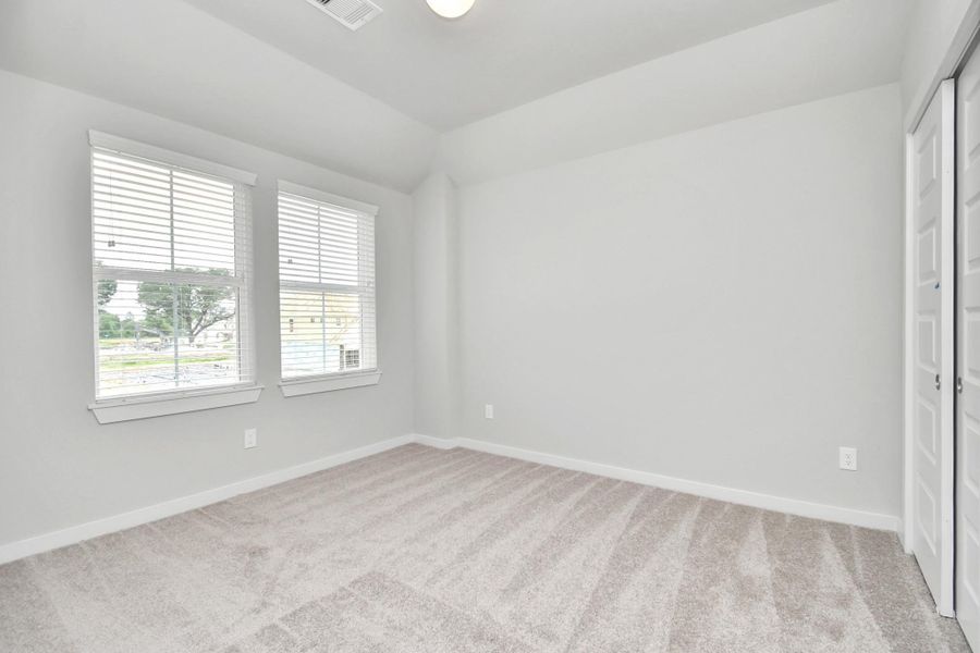 Generously sized secondary bedrooms, complete with spacious closets and soft, inviting carpeting. Sample photo of completed home with similar floor plan. Actual colors and selections may vary.