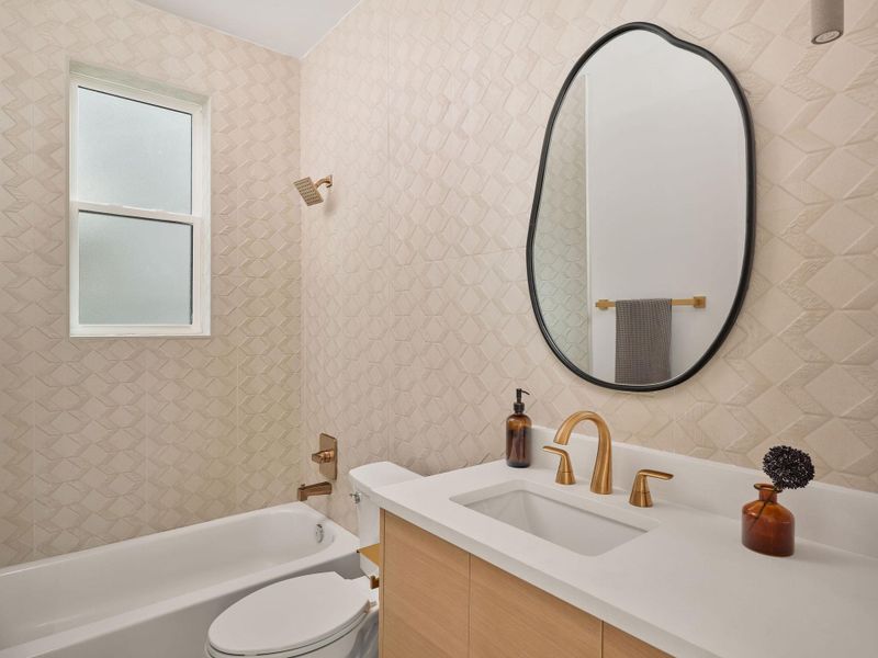 Bathroom featuring vanity and shower / bath combination