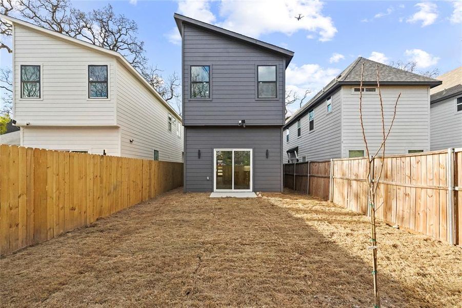 Rear view of house featuring a fenced backyard Rear view of house featuring a fenced backyard
