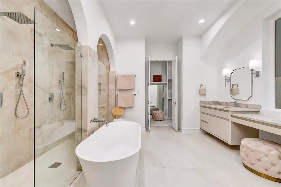 Full bathroom featuring a freestanding tub, walk in shower, vanity, and recessed lighting Full bathroom featuring a freestanding tub, walk in shower, vanity, and recessed lighting