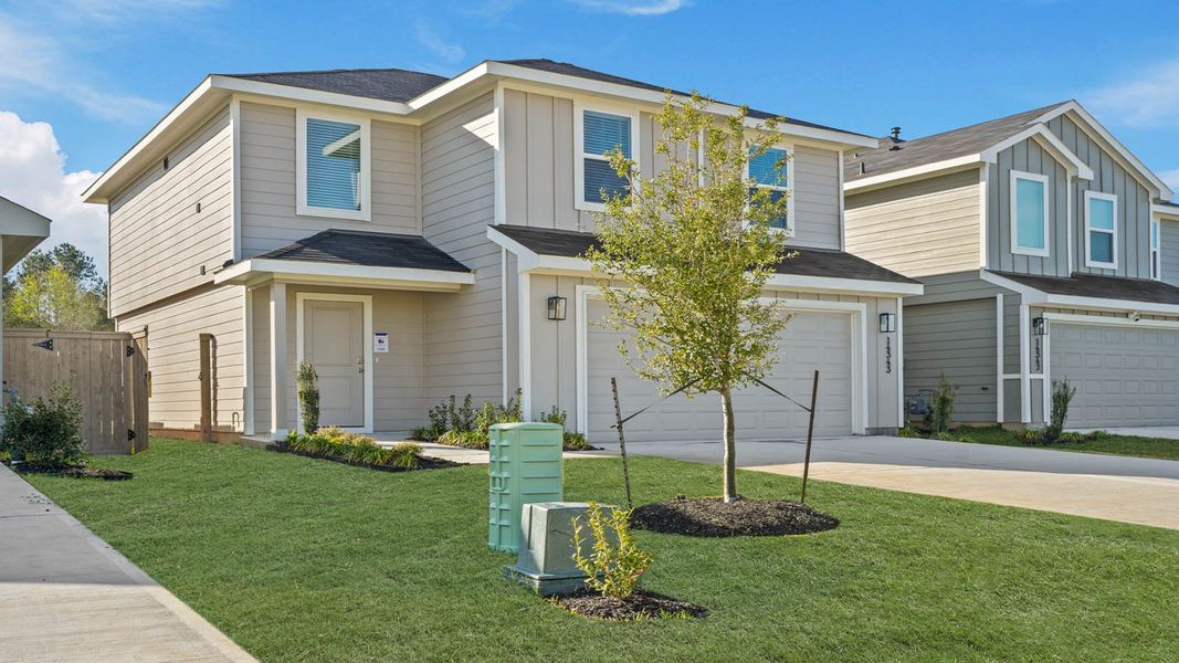 Front exterior of a new home in The Canopies, Splendora, TX, highlighting curb appeal (Image 15).
