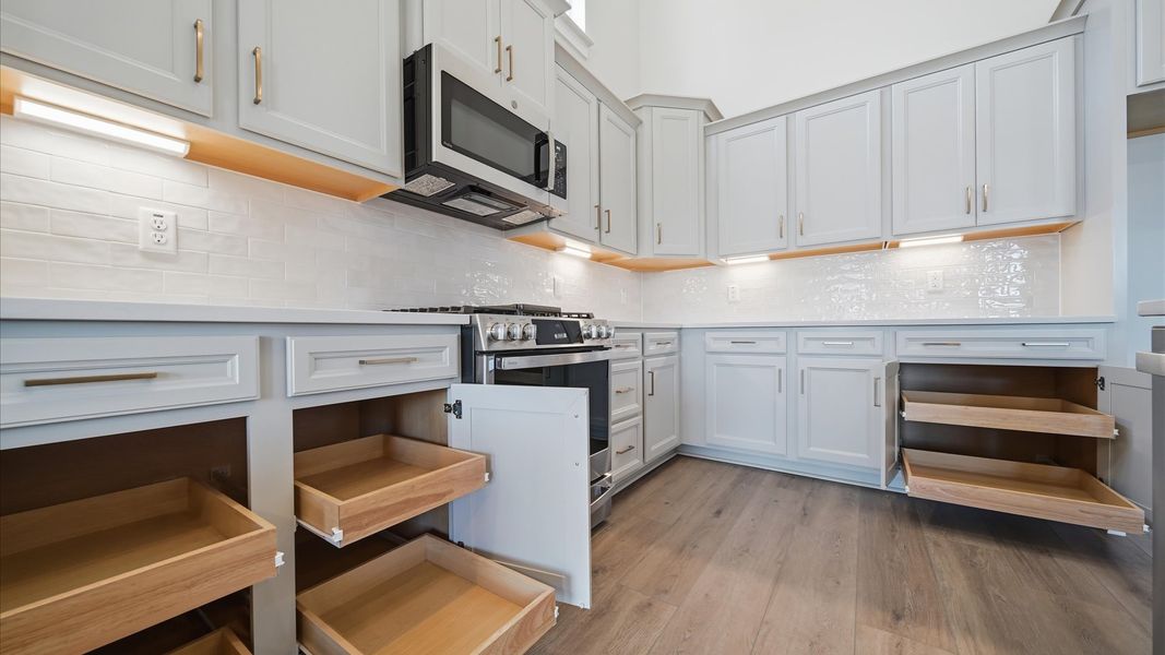 Accomplished design in a kitchen that blends function and form with abundant storage and sleek cabinetry at Iris Meadows