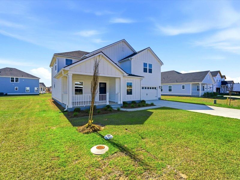 Front exterior of a new home in The Coves at Lakes of Cane Bay II, Summerville, SC, highlighting curb appeal (Image 2). Front exterior of a new home in The Coves at Lakes of Cane Bay II, Summerville, SC, highlighting curb appeal (Image 2).