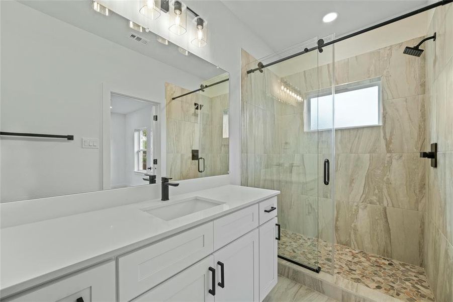 Bathroom featuring vanity and a stall shower Bathroom featuring vanity and a stall shower